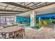 Indoor pool and seating area with colorful murals, providing a fun and vibrant recreational space at 3000 Ocean Blvd. # 1209, Myrtle Beach, SC 29577