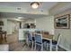 Dining area leading into kitchen equipped with granite countertops and stainless appliances at 3000 Ocean Blvd. # 1209, Myrtle Beach, SC 29577