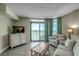 Bright living room featuring a serene ocean view through large sliding glass doors at 3000 Ocean Blvd. # 1209, Myrtle Beach, SC 29577