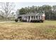 Cozy single-story brick home featuring a well-maintained front yard and covered porch at 3285 Della Rd., Longs, SC 29568