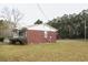 Side view of a charming single-story brick home with mature trees at 3285 Della Rd., Longs, SC 29568