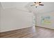 Bedroom featuring wood-look floors, ceiling fan, and an entry to the bathroom and walk-in closet at 411 Lifestyle Court, Surfside Beach, SC 29575