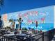 Outdoor patio with tables and chairs in front of a Surfside Beach mural at 411 Lifestyle Court, Surfside Beach, SC 29575