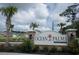 Ocean Palms community sign nestled among palm trees and colorful landscaping at 415 Lifestyle Court, Surfside Beach, SC 29575