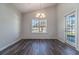 Bright dining area featuring a stylish chandelier, large window with natural light, and an adjacent door at 415 Lifestyle Court, Surfside Beach, SC 29575