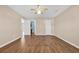 Bedroom with wood floors, ceiling fan, and access to bathroom at 4938 Trooper Ln., Loris, SC 29569