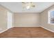 Cozy bedroom with wood floors, ceiling fan, and a large window at 4938 Trooper Ln., Loris, SC 29569