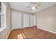 Spacious bedroom with a ceiling fan, hardwood floors and white closet doors at 4938 Trooper Ln., Loris, SC 29569