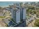 Stunning aerial view of Holiday Towers in Myrtle Beach, featuring parking, tennis court, and ocean views at 601 Mitchell Dr. # 203, Myrtle Beach, SC 29577