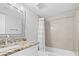 A stylish bathroom with a granite countertop, modern fixtures, and a tiled shower and tub at 601 Mitchell Dr. # 203, Myrtle Beach, SC 29577