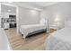 Well-lit bedroom featuring 2 twin beds with gray walls and white frame and furnishings, with a view to the kitchen at 601 Mitchell Dr. # 203, Myrtle Beach, SC 29577