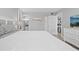 Well-lit bedroom with a queen-sized bed, dresser, and views to the ensuite bath and kitchen at 601 Mitchell Dr. # 203, Myrtle Beach, SC 29577