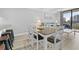 Living and dining area featuring a dining table with chairs, sofa, and outdoor views at 601 Mitchell Dr. # 203, Myrtle Beach, SC 29577