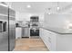Modern kitchen with stainless steel appliances, white cabinets, and stylish backsplash at 601 Mitchell Dr. # 203, Myrtle Beach, SC 29577