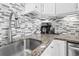 Close up of kitchen faucet, sink, granite countertop, coffee maker, toaster and tiled backsplash at 601 Mitchell Dr. # 203, Myrtle Beach, SC 29577