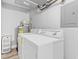 Well-lit laundry room featuring a washer, dryer, and water heater at 601 Mitchell Dr. # 203, Myrtle Beach, SC 29577