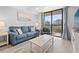 Comfortable living room featuring a sofa, accent chair, and balcony access with scenic views at 601 Mitchell Dr. # 203, Myrtle Beach, SC 29577