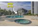 Enjoy this building's outdoor pool and hot tub with lounge chairs on the pool deck at 601 Mitchell Dr. # 203, Myrtle Beach, SC 29577