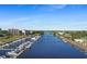 Scenic aerial view of a marina with boats docked along the riverbanks, set against a backdrop of buildings and lush greenery at 6095 Catalina Dr. # 1314, North Myrtle Beach, SC 29582