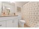 Well-lit bathroom with a white vanity, seashell themed shower curtain and neutral wall art at 6095 Catalina Dr. # 1314, North Myrtle Beach, SC 29582