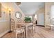 Cozy dining area with light wood floors, a round table, and stylish seating under a high ceiling at 6095 Catalina Dr. # 1314, North Myrtle Beach, SC 29582