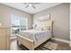 Comfortable bedroom with a ceiling fan, a window, and a bed with a blue and yellow patterned blanket at 70 Addison Cottage Way # 121 & 32, Murrells Inlet, SC 29576