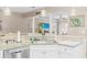 Modern kitchen featuring white cabinetry, stainless steel dishwasher, granite countertops and an open concept design at 70 Addison Cottage Way # 121 & 32, Murrells Inlet, SC 29576