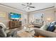 Cozy living room featuring ceiling fan, comfortable seating, decorative pillows, and beach-themed decor at 70 Addison Cottage Way # 121 & 32, Murrells Inlet, SC 29576