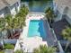 Community swimming pool surrounded by lush greenery and lounge chairs with clear water at 70 Addison Cottage Way # 121 & 32, Murrells Inlet, SC 29576