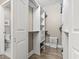 Spacious walk-in closet with custom shelves and drawers, adjacent to a full bathroom at 70 Addison Cottage Way # 121 & 32, Murrells Inlet, SC 29576