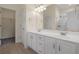 Bathroom featuring a double sink vanity and an open door leading to a walk-in closet at 1019 Hillsdale Dr., Little River, SC 29566