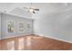 An empty bedroom with hardwood floors and plenty of natural light from three windows at 1019 Hillsdale Dr., Little River, SC 29566