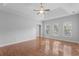 Bedroom featuring hardwood floors, a tray ceiling, and multiple windows at 1019 Hillsdale Dr., Little River, SC 29566