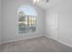 Bedroom with a large arch window, neutral paint and carpet at 1019 Hillsdale Dr., Little River, SC 29566