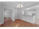 Bright dining area with hardwood floors, modern chandelier, and open access to the kitchen at 1019 Hillsdale Dr., Little River, SC 29566