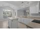Bright kitchen with white cabinets, island, and modern sink, enhanced by natural light from nearby windows at 1019 Hillsdale Dr., Little River, SC 29566