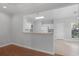Open-concept kitchen showcasing white cabinetry, island, and modern appliances, adjacent to the dining area at 1019 Hillsdale Dr., Little River, SC 29566