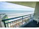 Balcony view of the ocean and beach. Features seating and a blue railing at 1105 S Ocean Blvd. # 1106, Myrtle Beach, SC 29577