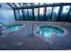 Dual hot tubs surrounded by brick flooring and a windowed enclosure at 1105 S Ocean Blvd. # 1106, Myrtle Beach, SC 29577