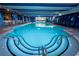 Inviting indoor pool area with elegant blue accents and clear windows providing natural light at 1105 S Ocean Blvd. # 1106, Myrtle Beach, SC 29577
