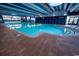 Beautiful indoor pool featuring a unique brick border and ample sunlight, perfect for year-round enjoyment at 1105 S Ocean Blvd. # 1106, Myrtle Beach, SC 29577
