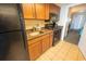 A compact kitchenette featuring modern appliances, wooden cabinetry, and granite countertops, adjacent to the bedroom area at 1105 S Ocean Blvd. # 1106, Myrtle Beach, SC 29577