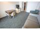 The living room features a gray sofa and a small dining table, complemented by light-colored walls and modern décor at 1105 S Ocean Blvd. # 1106, Myrtle Beach, SC 29577