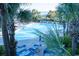Inviting swimming pool surrounded by palm trees, sun loungers, and umbrellas at 1105 S Ocean Blvd. # 1106, Myrtle Beach, SC 29577