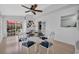 Open dining area with glass table, white chairs, and view of patio with red umbrella at 119 Gully Branch Dr. # 4, Myrtle Beach, SC 29572