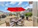 Outdoor patio with a table, red umbrella, white fence and a view of the backyard at 119 Gully Branch Dr. # 4, Myrtle Beach, SC 29572