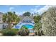 Community pool surrounded by lounge chairs, tropical plants and a clubhouse at 119 Gully Branch Dr. # 4, Myrtle Beach, SC 29572