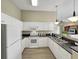 Well-lit kitchen features granite countertops, white appliances, and ample storage space at 601 Hillside Dr. N # 4535, North Myrtle Beach, SC 29582