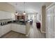 Bright kitchen featuring white cabinets, granite countertops, and stainless steel dishwasher open to the dining area at 601 Hillside Dr. N # 4535, North Myrtle Beach, SC 29582