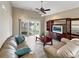 Comfortable living room with a plush sofa, coffee table, entertainment center, and a sliding door to an outdoor patio at 601 Hillside Dr. N # 4535, North Myrtle Beach, SC 29582